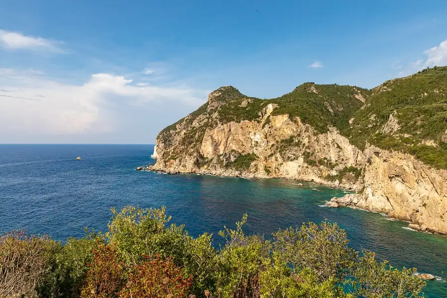The green headlands and coves of Paleokastritsa on the northwest coast of Corfu, wooded promontories dropping into clear water