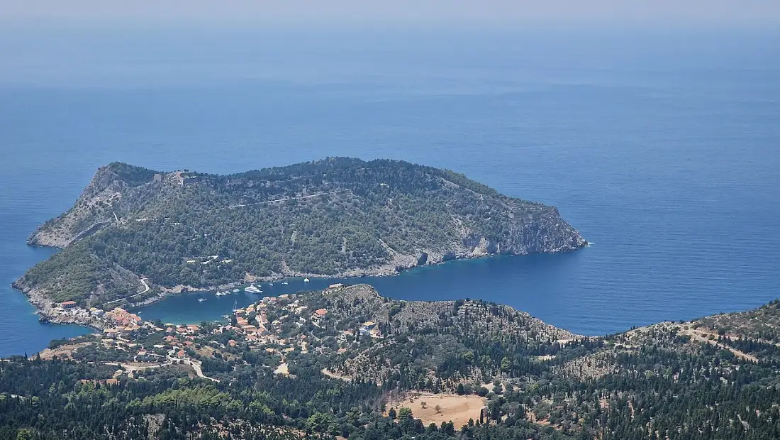 The village of Assos on its narrow isthmus in Kefalonia, with the wooded headland and Venetian castle behind