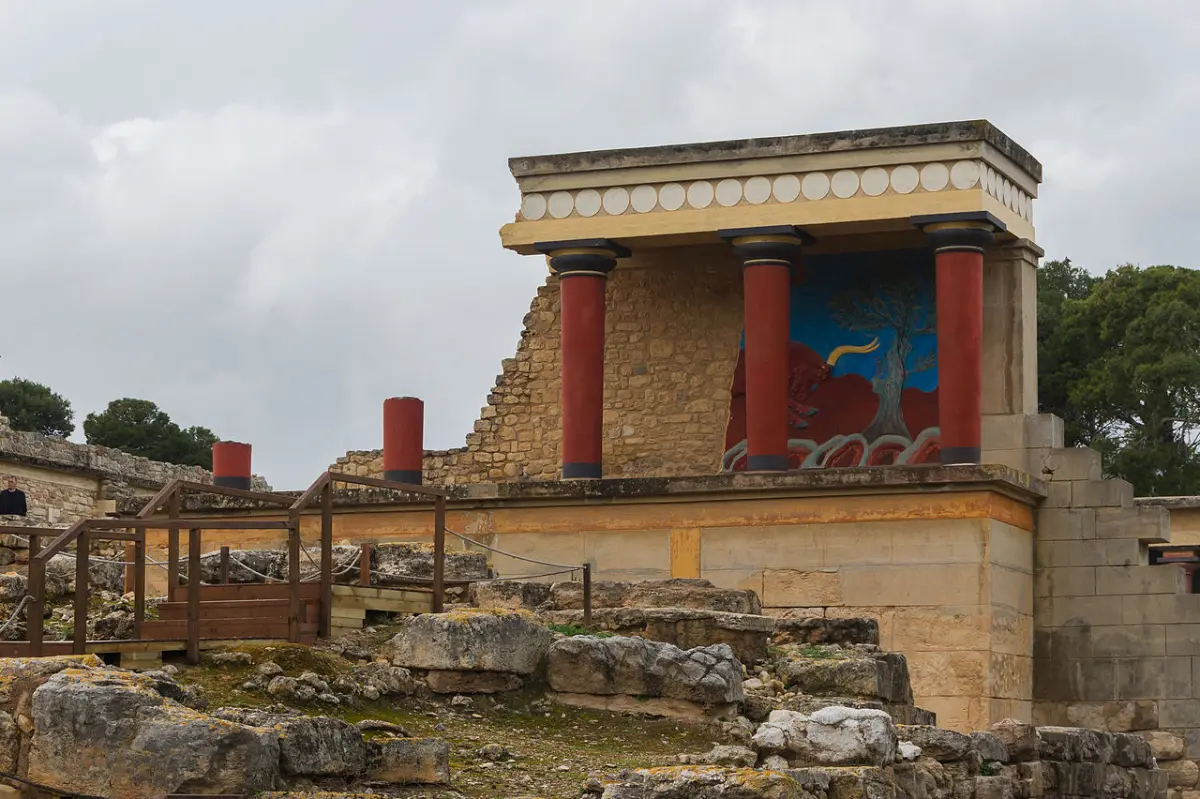 The reconstructed north entrance of the Palace of Knossos, with tapering red columns and a bull relief above
