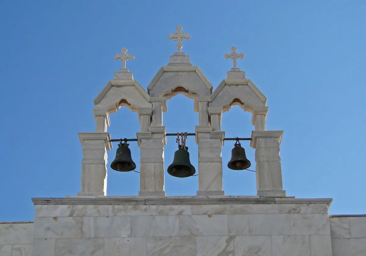 The white walls and bell tower of the Panagia Tourliani monastery in the village square at Ano Mera on Mykonos