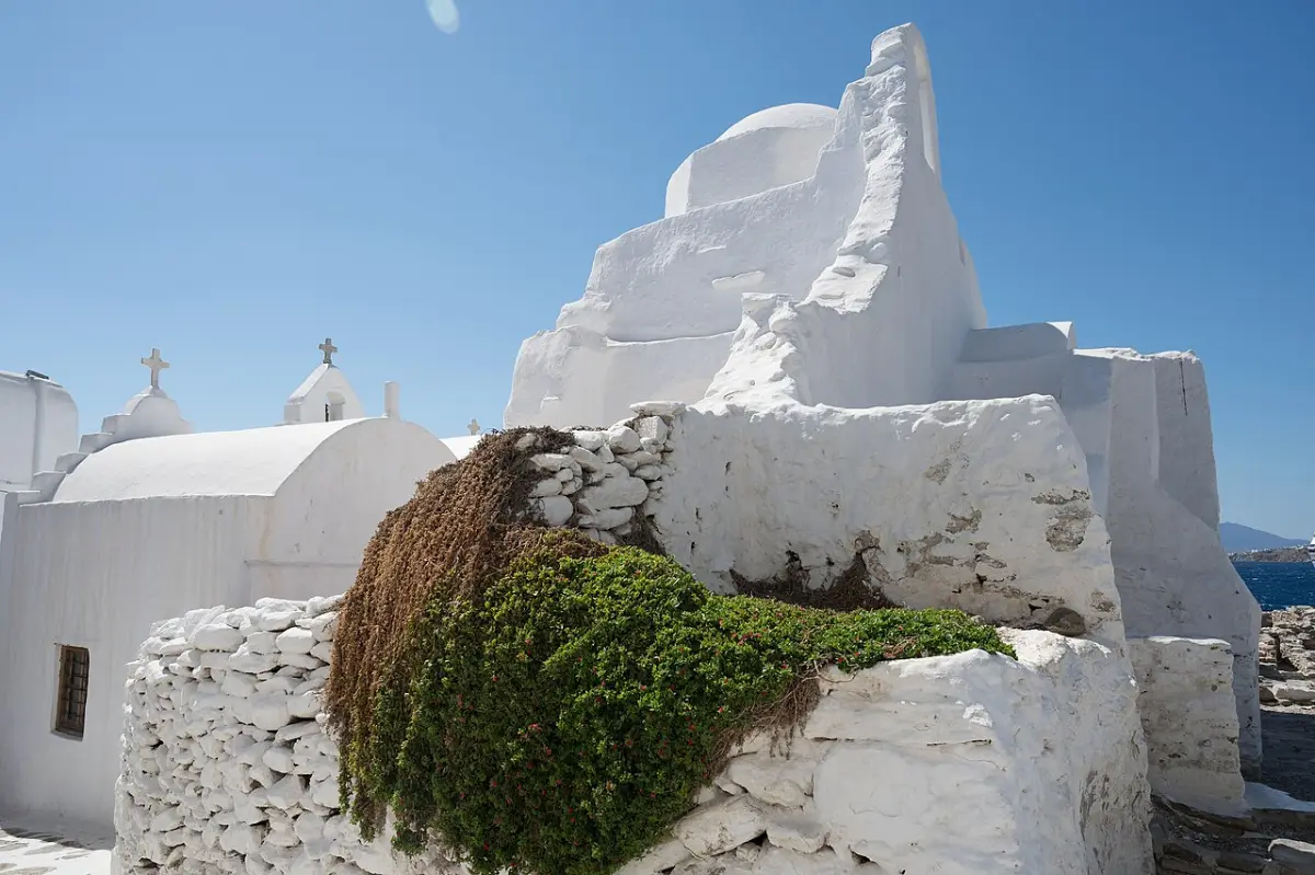 The whitewashed Paraportiani church and the Kastro edge of Mykonos Town above the sea