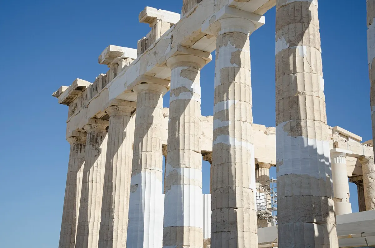 Bright white newly carved marble set directly against weathered, honey-toned ancient marble on the Parthenon