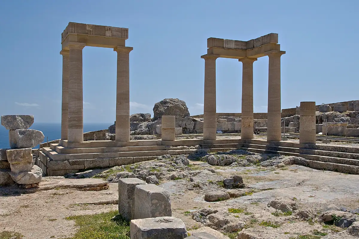 Restored Doric porticoes of the Temple of Athena Lindia on the summit of the Lindos acropolis above the sea, Rhodes