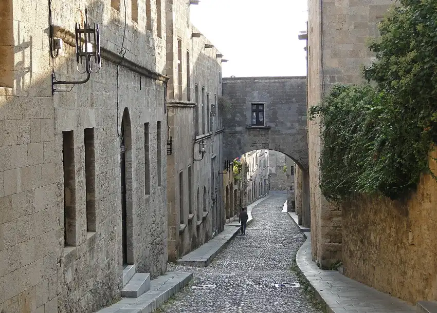 The cobbled Street of the Knights in Rhodes Old Town running uphill between the stone inns of the Knights of St John