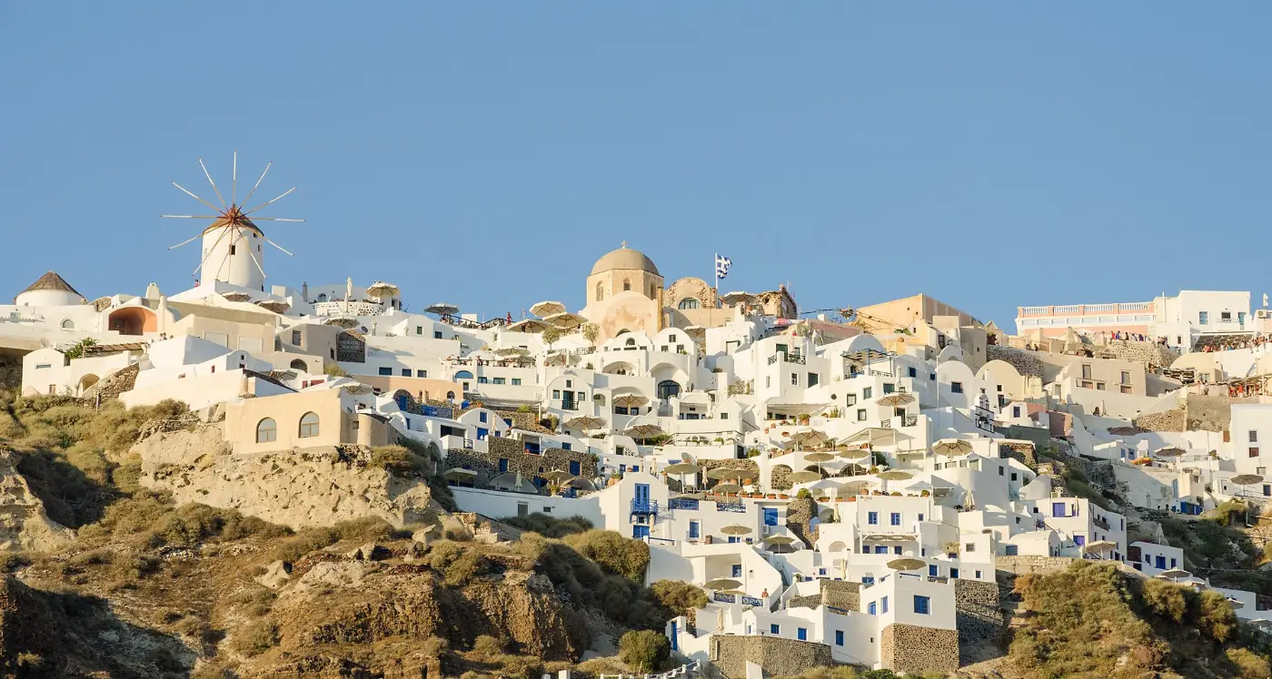Oia stepping down the Santorini caldera edge in whitewashed terraces above the sea
