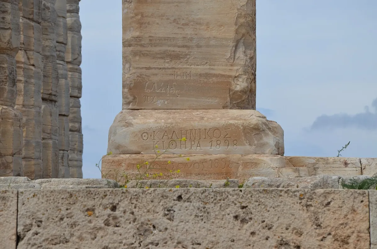 Names carefully cut into the weathered marble of a column at the Temple of Poseidon at Sounion