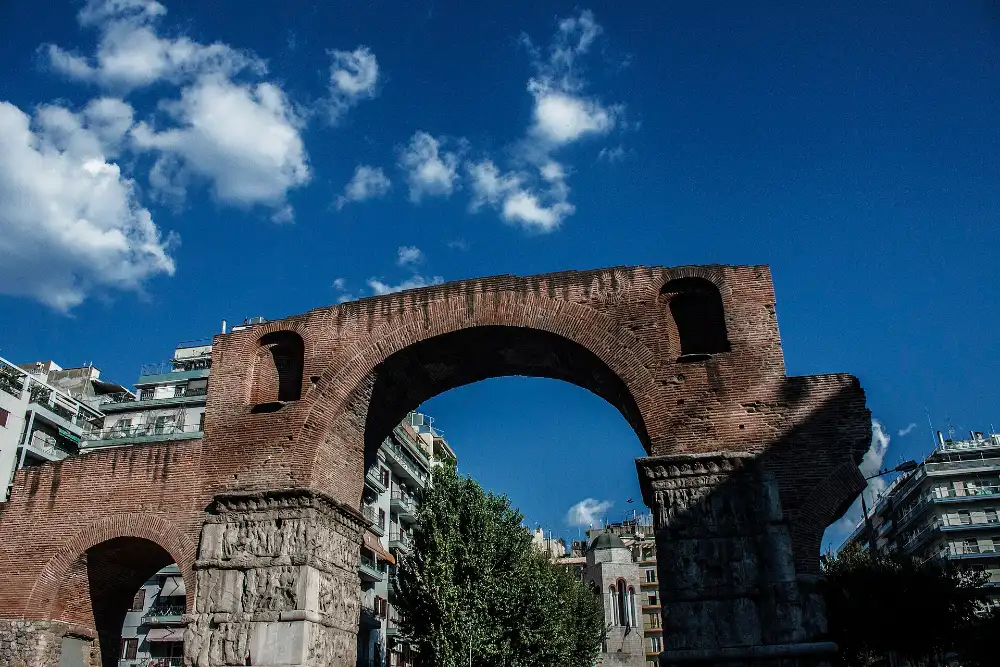 The brick Arch of Galerius standing over a paved square in central Thessaloniki