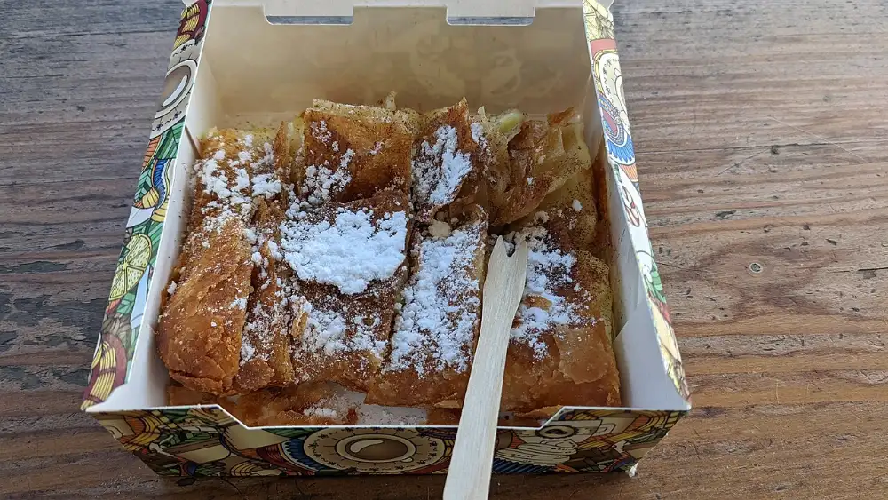 Bougatsa, layered filo pastry with custard filling, cut into squares
