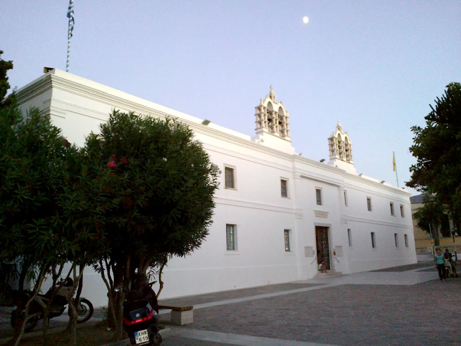 The white bell tower and walls of the Ekatontapiliani church on Paros