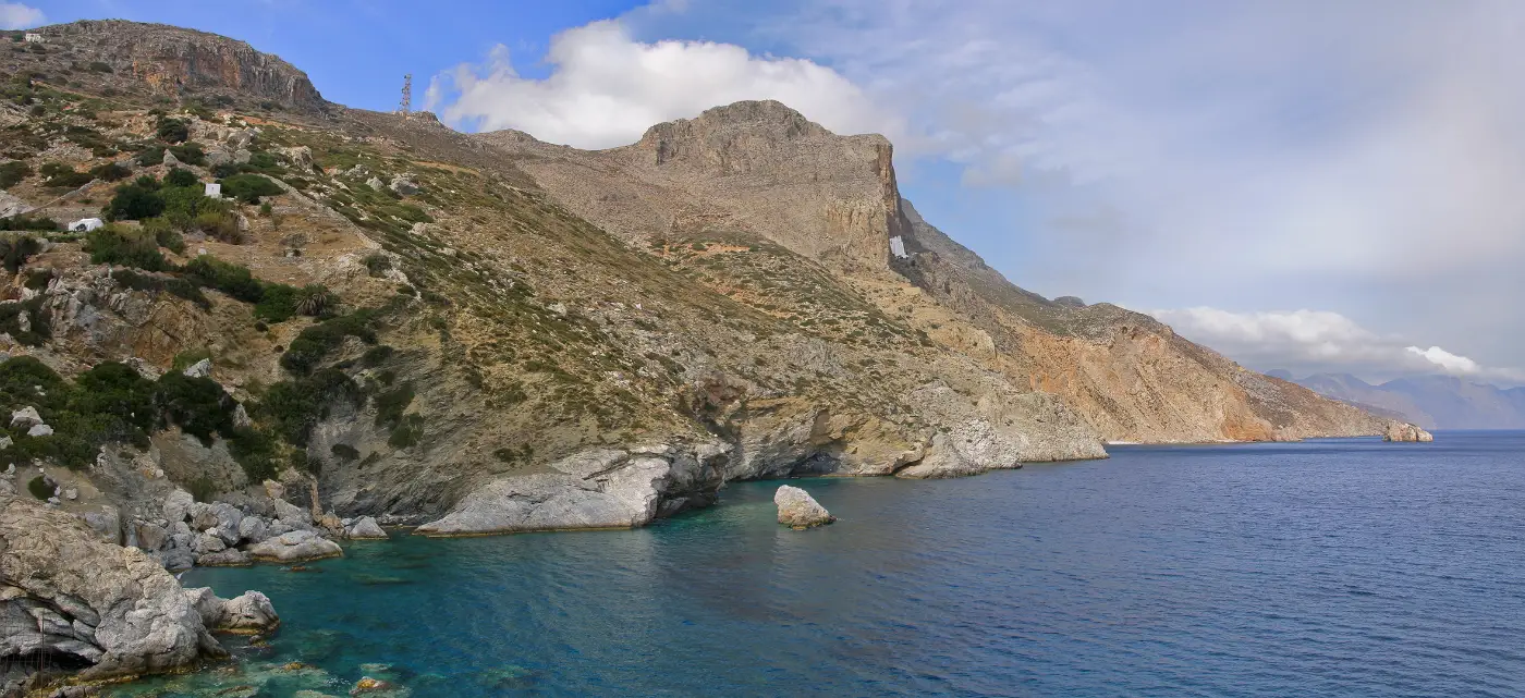 The bare east coast of Amorgos, the cliff wall that carries the Hozoviotissa monastery