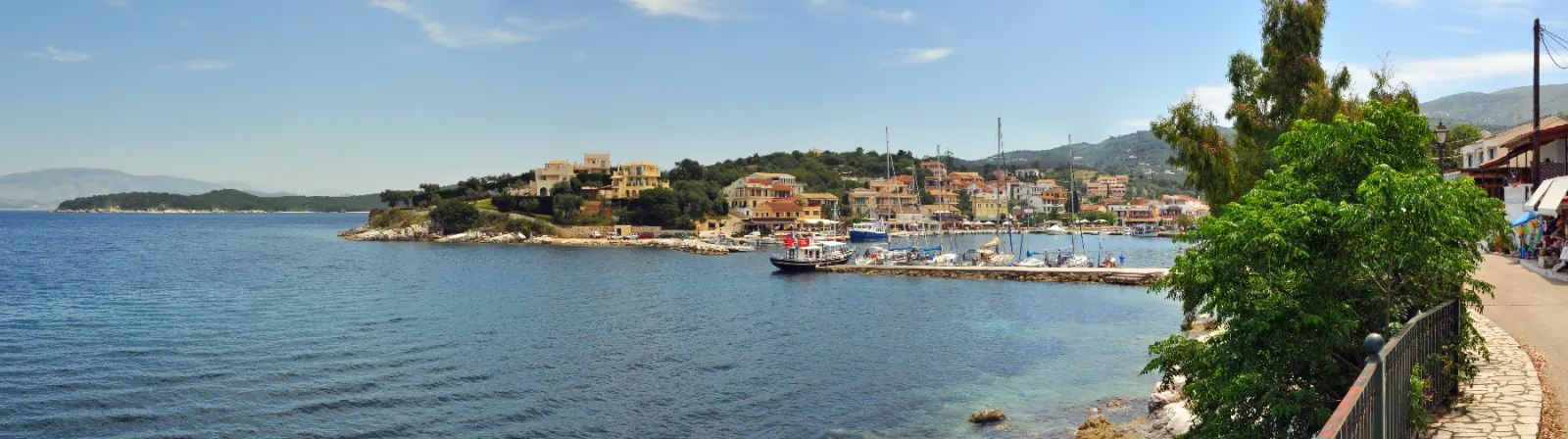 Kassiopi on Corfu, the harbour and village below a wooded headland