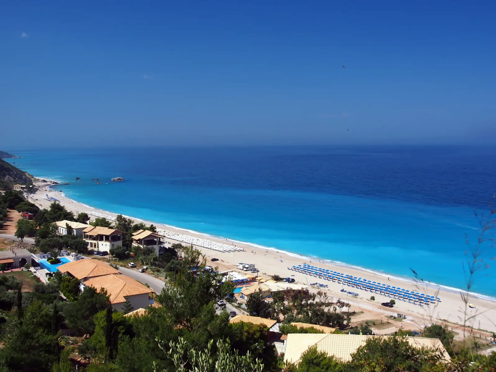 Kathisma beach on Lefkada, a long pale strip against deep blue water