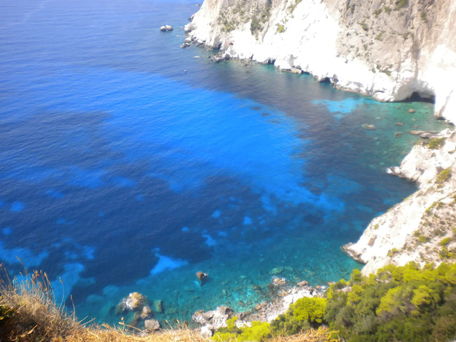 The Keri caves on Zakynthos, white cliffs dropping into vivid blue water