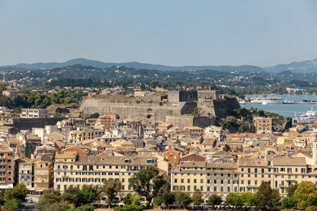 Corfu old town from above, tiled roofs running down to the sea
