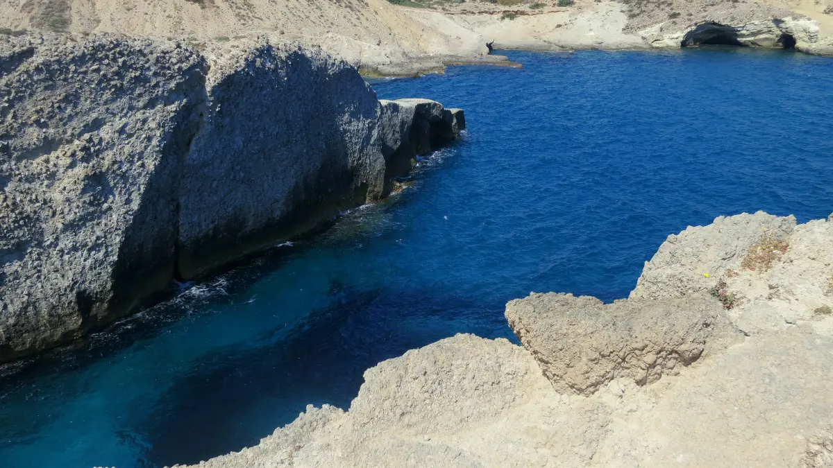 Papafragas: a slot of turquoise water in white rock