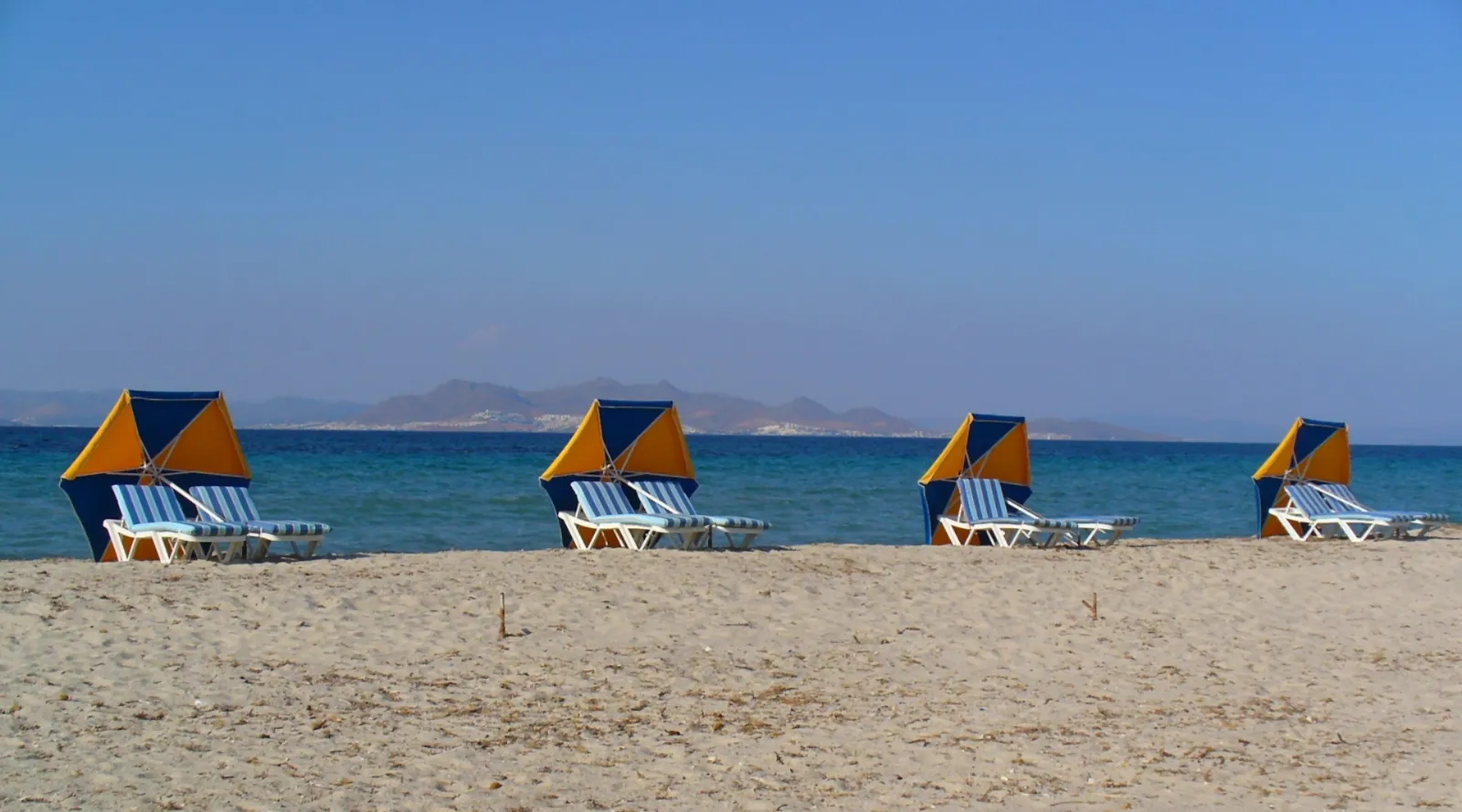 Thatched umbrellas along the sand at Tigaki on Kos
